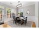 Dining room with black chairs, wood table, area rug and plenty of natural light at 3499 Henderson Reserve, Atlanta, GA 30341