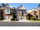 Beautiful brick townhome featuring an attached two-car garage and landscaped front yard at 3499 Henderson Reserve, Atlanta, GA 30341