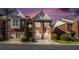 Townhome exteriors with attached garages and manicured landscaping on a beautiful sunset evening at 3499 Henderson Reserve, Atlanta, GA 30341