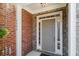 Welcoming front entrance with a gray door, brick accents, and decorative sidelights at 3499 Henderson Reserve, Atlanta, GA 30341