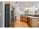 Open kitchen with wood cabinets, stainless steel appliances and hardwood floors at 3499 Henderson Reserve, Atlanta, GA 30341