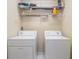 Laundry room with a washer, dryer and shelving unit for storage at 3499 Henderson Reserve, Atlanta, GA 30341