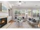 Bright living room with fireplace, neutral furniture and large windows providing natural light at 3499 Henderson Reserve, Atlanta, GA 30341