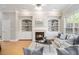 Inviting living room with a fireplace, built-in bookshelves, and a large window at 3499 Henderson Reserve, Atlanta, GA 30341