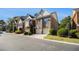Street view showcases attached townhomes with brick exteriors, garages, and landscaped front yards at 3499 Henderson Reserve, Atlanta, GA 30341