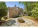 Exterior of brick home with lush green lawn and stone firepit feature at 385 Laurel Chase Ct, Atlanta, GA 30327