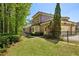 Spacious backyard of a brick home featuring lush green grass and mature trees, perfect for outdoor activities and relaxation at 385 Laurel Chase Ct, Atlanta, GA 30327