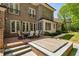 Exterior of brick home with back patio, inground spa and luscious green yard with mature trees at 385 Laurel Chase Ct, Atlanta, GA 30327