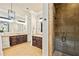 Spacious bathroom featuring double vanities, a walk-in shower with stone tile, and elegant fixtures at 385 Laurel Chase Ct, Atlanta, GA 30327