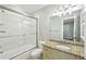 Bathroom with tub shower combo featuring a glass door and granite countertops at 385 Laurel Chase Ct, Atlanta, GA 30327