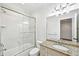 Bathroom with tub shower combo featuring a glass door and granite countertops at 385 Laurel Chase Ct, Atlanta, GA 30327
