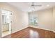 Bedroom with hardwood floors, a window with blinds, and an ensuite bathroom at 385 Laurel Chase Ct, Atlanta, GA 30327