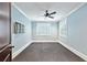 Light-filled bedroom features a ceiling fan, neutral carpeting and paint, large windows, and custom shutters at 385 Laurel Chase Ct, Atlanta, GA 30327