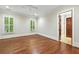 Bright bedroom featuring beautiful hardwood floors, a ceiling fan, and doorway to bathroom at 385 Laurel Chase Ct, Atlanta, GA 30327