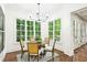 Cozy breakfast nook with natural light and views of the lush greenery outside the windows at 385 Laurel Chase Ct, Atlanta, GA 30327