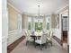 Elegant dining room features a modern chandelier, wainscoting, and large windows at 385 Laurel Chase Ct, Atlanta, GA 30327