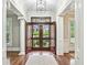 Inviting entryway with hardwood floors, white trim, and views of the lush front yard at 385 Laurel Chase Ct, Atlanta, GA 30327