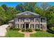 Stunning brick home featuring lush landscaping, a balanced facade, and an inviting entrance at 385 Laurel Chase Ct, Atlanta, GA 30327