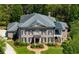 Elegant brick home with lush landscaping, symmetrical design, and a welcoming entrance, exuding classic charm and curb appeal at 385 Laurel Chase Ct, Atlanta, GA 30327