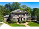 Elegant two-story brick home with a manicured lawn, charming landscaping, and a welcoming entrance, showcasing curb appeal at 385 Laurel Chase Ct, Atlanta, GA 30327