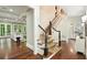 View of entry foyer with hardwood floors, staircase, and natural light from large windows at 385 Laurel Chase Ct, Atlanta, GA 30327