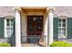 Grand entrance with stone columns, elegant ironwork, and a beautifully crafted wood door at 385 Laurel Chase Ct, Atlanta, GA 30327