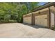 Attached two-car garage featuring a basketball hoop and spacious driveway for convenient parking and recreational activities at 385 Laurel Chase Ct, Atlanta, GA 30327