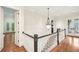 Bright hallway with gleaming hardwood floors, elegant lighting, and views to the outdoors through glass doors at 385 Laurel Chase Ct, Atlanta, GA 30327