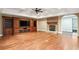 Spacious living room featuring hardwood floors, a fireplace, and custom built-in shelving and cabinets at 385 Laurel Chase Ct, Atlanta, GA 30327