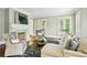 Comfortable seating in living room with fireplace and natural light from French doors at 385 Laurel Chase Ct, Atlanta, GA 30327