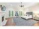 Main bedroom with hardwood floors, fireplace, and French doors at 385 Laurel Chase Ct, Atlanta, GA 30327