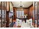 Richly paneled office with built-in shelving, fireplace and modern decor at 385 Laurel Chase Ct, Atlanta, GA 30327
