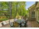 Back patio with brick pavers, a built-in spa, and an outdoor dining area surrounded by lush landscaping at 385 Laurel Chase Ct, Atlanta, GA 30327