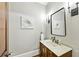Stylish powder room with antique vanity and modern fixtures at 385 Laurel Chase Ct, Atlanta, GA 30327