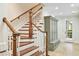 Beautiful staircase with hardwood steps, white risers, and a convenient built-in mudroom style storage at 385 Laurel Chase Ct, Atlanta, GA 30327