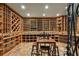 A large custom wine cellar with wooden racks and shelving provides ample space to display any collection at 385 Laurel Chase Ct, Atlanta, GA 30327