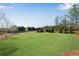 Expansive green backyard with mature trees, perfect for outdoor activities and relaxation at 3950 Grandview Manor Dr, Cumming, GA 30028