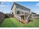 A fenced backyard with a wooden deck, stairs, and green grass, creating a private outdoor space at 3950 Grandview Manor Dr, Cumming, GA 30028