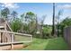 Backyard featuring a well-maintained lawn, a black metal fence, and an access stair from the deck at 3950 Grandview Manor Dr, Cumming, GA 30028