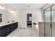 Primary bathroom featuring tiled walk-in shower, soaking tub, double vanity and neutral walls at 3950 Grandview Manor Dr, Cumming, GA 30028
