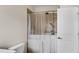 Bathroom featuring a walk-in tub with shower, tiled walls, and white door at 3950 Grandview Manor Dr, Cumming, GA 30028