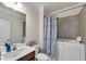 Bathroom featuring walk-in tub, vanity and large patterned shower curtain at 3950 Grandview Manor Dr, Cumming, GA 30028