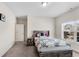 Bright bedroom featuring a full-sized bed, a nightstand, and a window with natural light at 3950 Grandview Manor Dr, Cumming, GA 30028