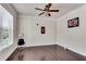 Versatile living space features hardwood floors, a ceiling fan, and large windows providing ample natural light at 3950 Grandview Manor Dr, Cumming, GA 30028