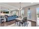 Bright dining area features a modern table set, hardwood floors, and flows into the living room at 3950 Grandview Manor Dr, Cumming, GA 30028