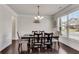 Formal dining room showcases dark hardwood floors, white walls and a large window with plenty of sunlight at 3950 Grandview Manor Dr, Cumming, GA 30028