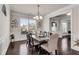 Charming dining room featuring hardwood floors, neutral walls, white trim, and natural light from large windows at 3950 Grandview Manor Dr, Cumming, GA 30028