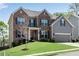 Attractive two-story home with brick and gray siding, complemented by a well-maintained lawn and landscaping at 3950 Grandview Manor Dr, Cumming, GA 30028
