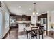 Spacious kitchen features dark cabinets, stainless appliances, granite countertops and a large center island at 3950 Grandview Manor Dr, Cumming, GA 30028