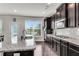 Modern kitchen with granite countertops, dark wood cabinets, stainless steel appliances, and lots of light at 3950 Grandview Manor Dr, Cumming, GA 30028